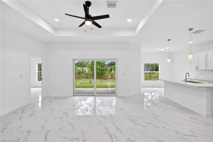 Tray ceilings paired with modern floors create a stylish and contemporary look.