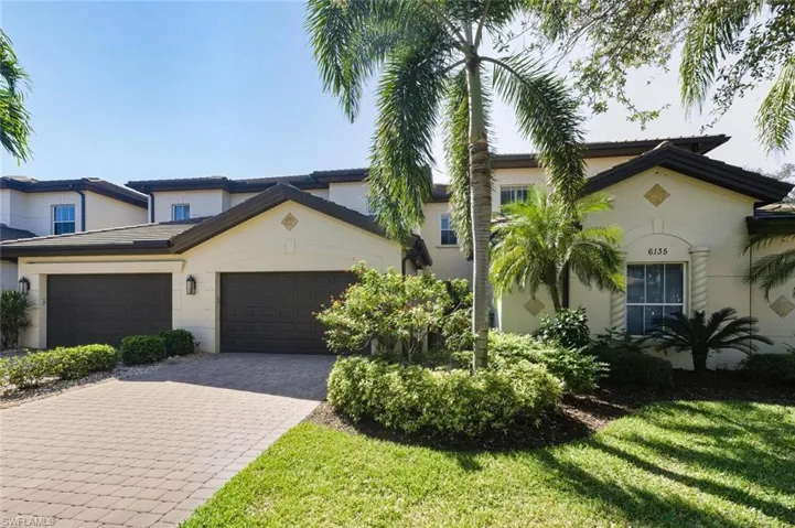 Double car-garage with lush landscaping