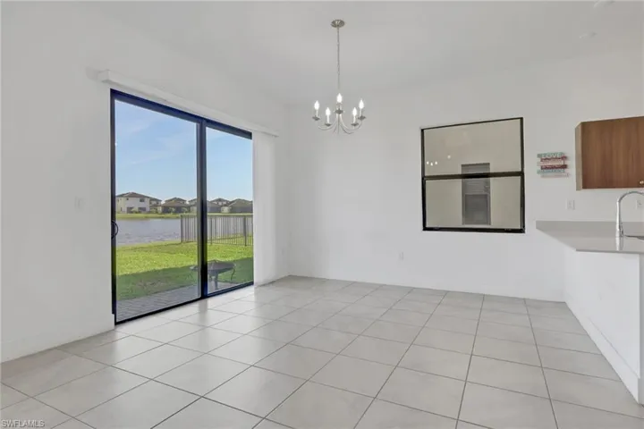 Dining area off the kitchen with access to the backyard. Gorgeous lake view!
