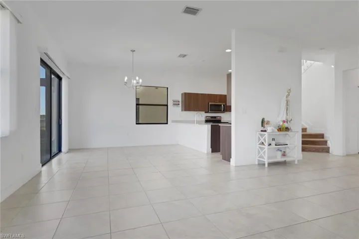 Spacious living & dining area with access to the backyard and gorgeous lake view. Tons of natural lighting!