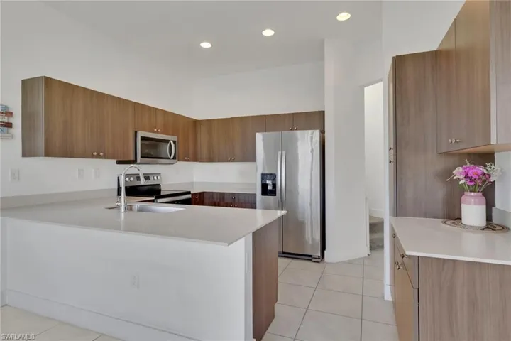 Sleek, modern kitchen with quartz countertops, stainless steel appliances, beautiful wood cabinets, large pantry, ample cabinet/counter space!
