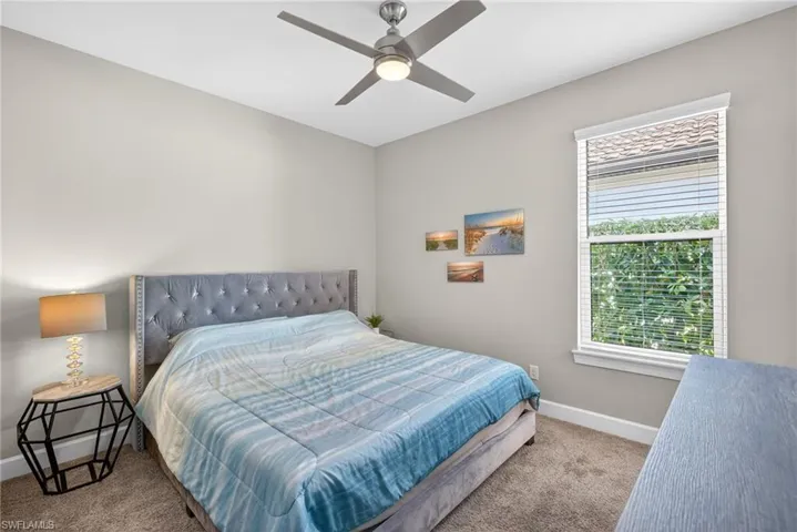 Bedroom 4 with carpet flooring and a ceiling fan with a king size bed.
