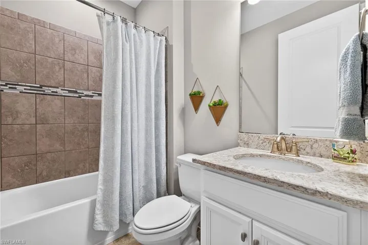 Bathroom with vanity and shower / bath combo