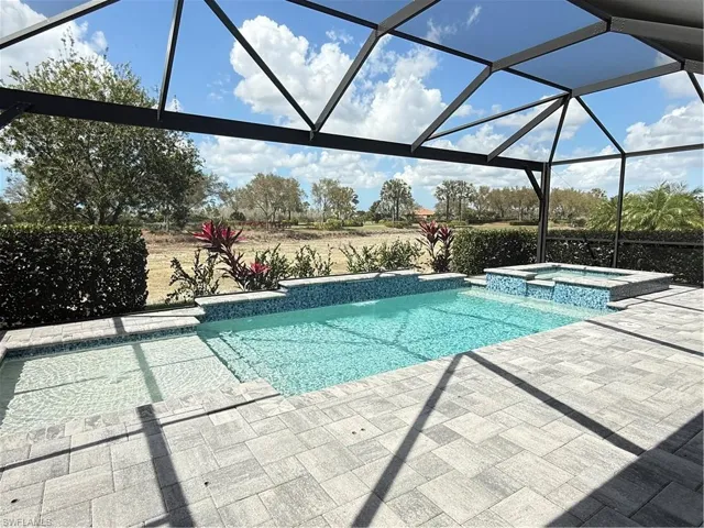 Pool and spa in a screened in lanai