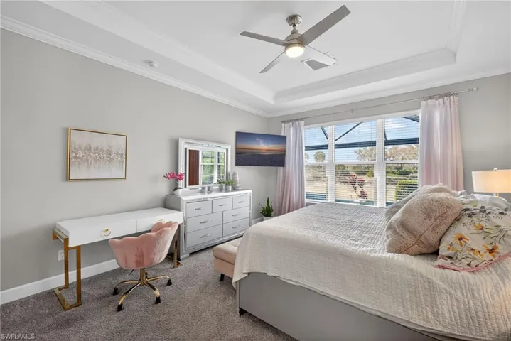 Bedroom with crown molding, carpet, ceiling fan, and a desk