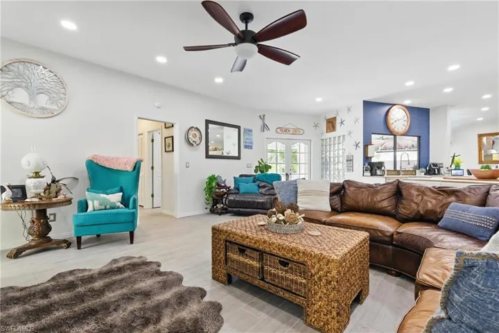 Living area featuring recessed lighting, light wood-type flooring, baseboards, and ceiling fan