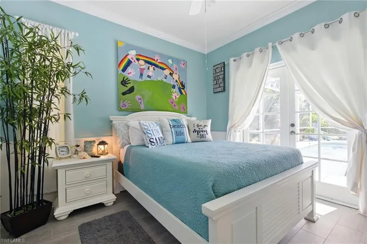 Bedroom featuring access to outside, french doors, and crown molding