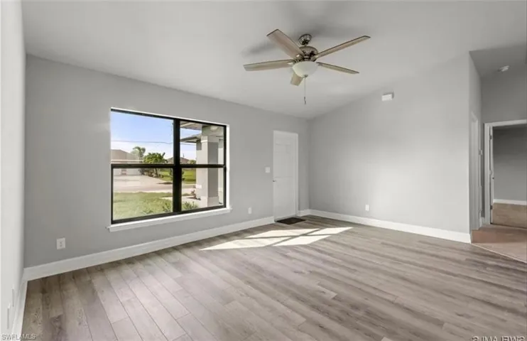Spare room with light wood-type flooring and ceiling fan