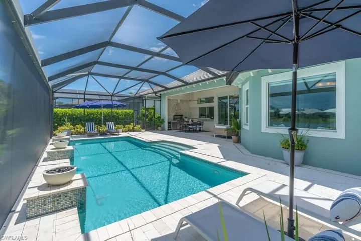 Multiple gathering areas for relaxation are found under the huge panoramic screened-in lanai