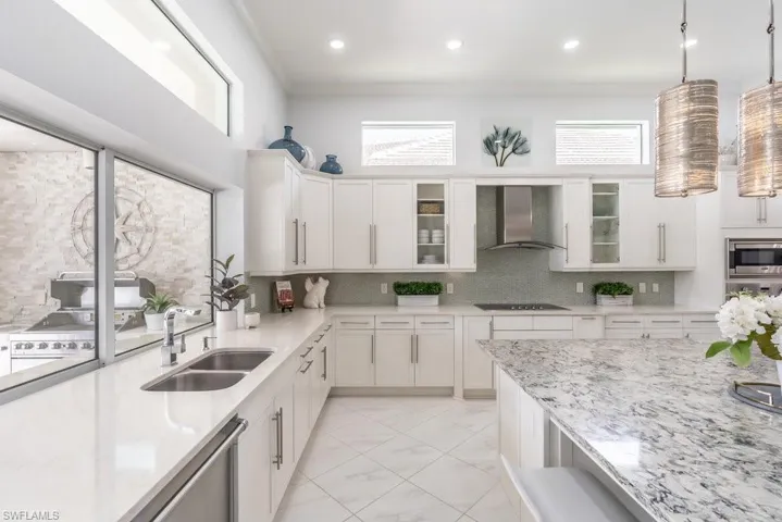 Abundent cabinetry and a pass through window that disappears into the wall makes it convenient to serve food through the kitchen to the outdoor dining area