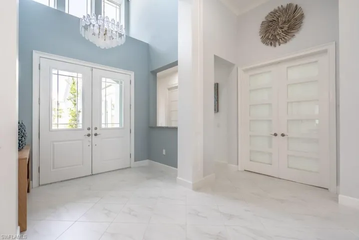 double french doors open to a bedroom suite