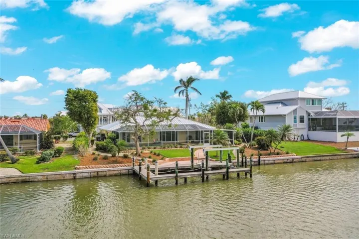 Dock area with a residential view, a lanai, and a water view