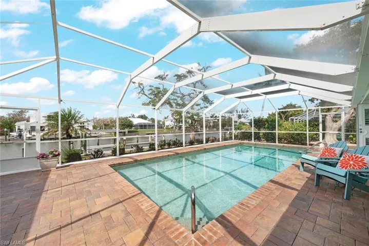 Outdoor pool with a lanai and a patio