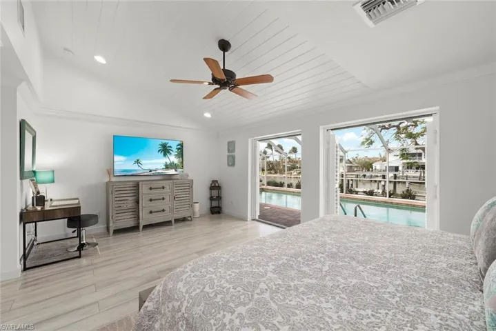 Bedroom with lofted ceiling, visible vents, wood finished floors, access to outside, and wooden ceiling