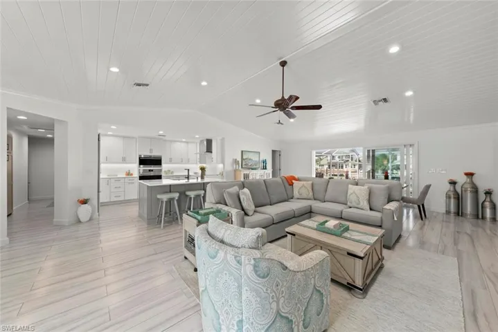 Living area with lofted ceiling, wood ceiling, visible vents, and recessed lighting