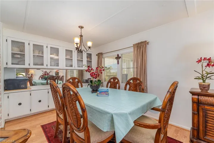 Dining area with a notable chandelier and light hardwood / wood-style flooring
