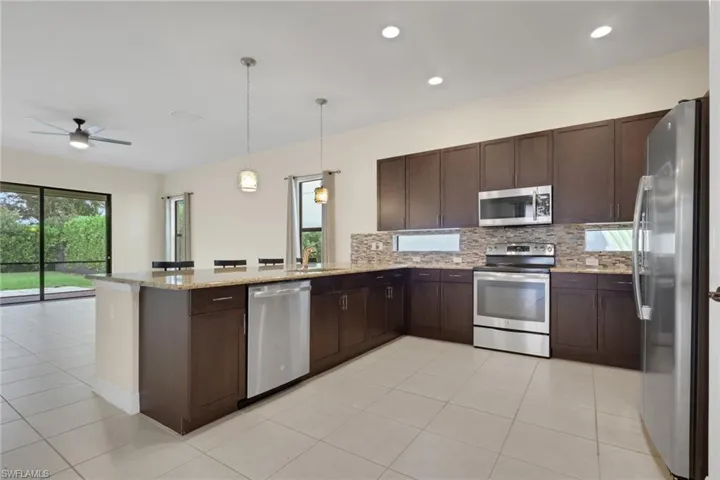 Kitchen with granite countertops and transom glass lighting