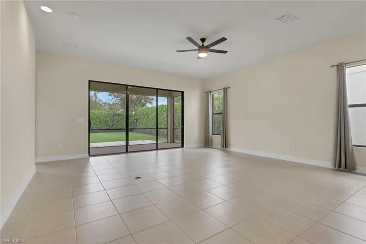 Sliders lead to the fenced in yard; 19.6 x 20 with 10 ft ceilings