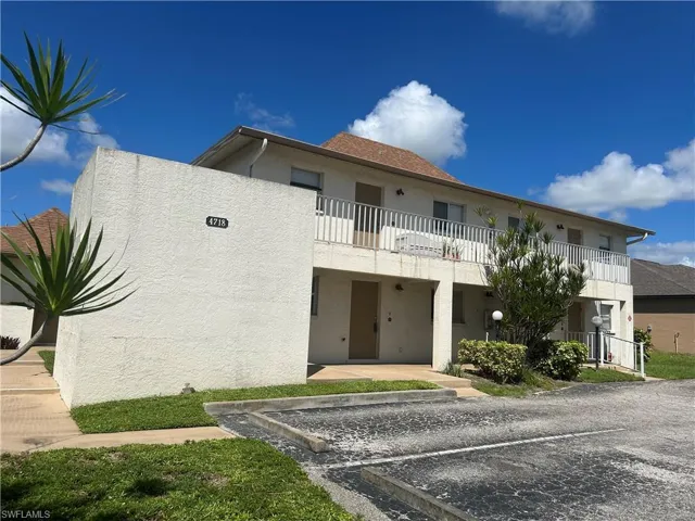 View of property with uncovered parking