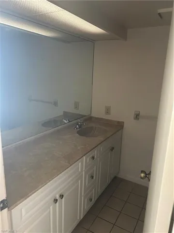 Bathroom featuring light tile patterned floors and vanity
