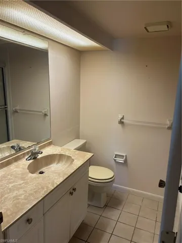 Bathroom featuring light tile patterned floors and vanity