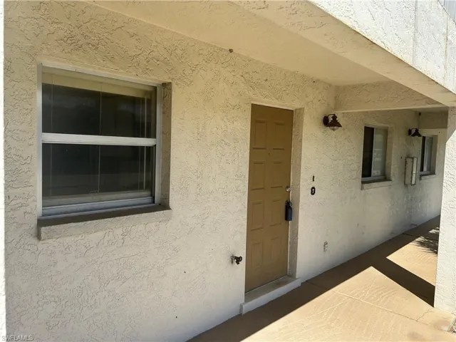 Property entrance with stucco siding