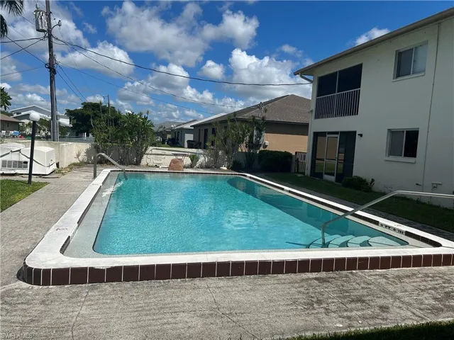 Community pool featuring a patio area