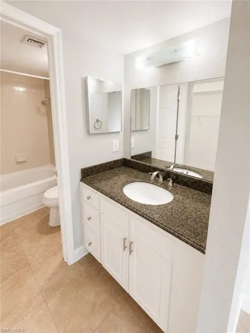 Vanity with a granite-style countertop and an integrated oval sink