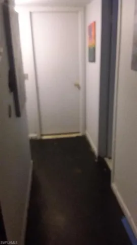 Hallway featuring baseboards