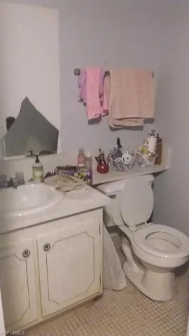 Half bath featuring vanity and tile patterned flooring