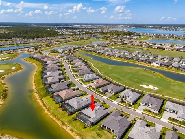 Birds eye view of property featuring a water view, a residential view, and golf course view