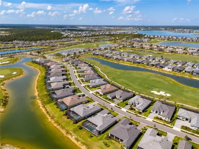 Drone / aerial view featuring a residential view, view of golf course, and a water view