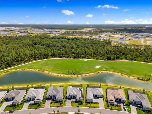 Aerial view featuring a water view, golf course view, and a residential view