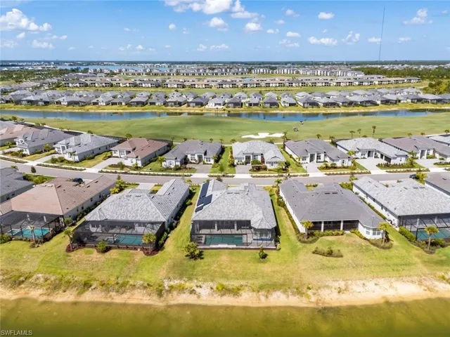 Drone / aerial view with a water view, a residential view, and golf course view