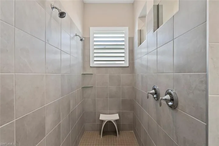 Full bath featuring tiled shower