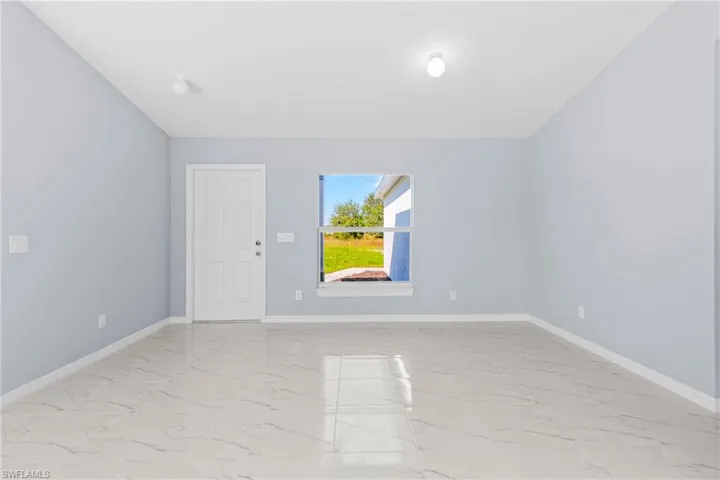 Empty room with light marble finish floors and baseboards