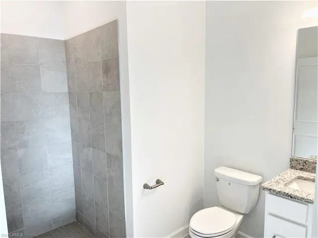 Full bathroom with vanity and a tile shower