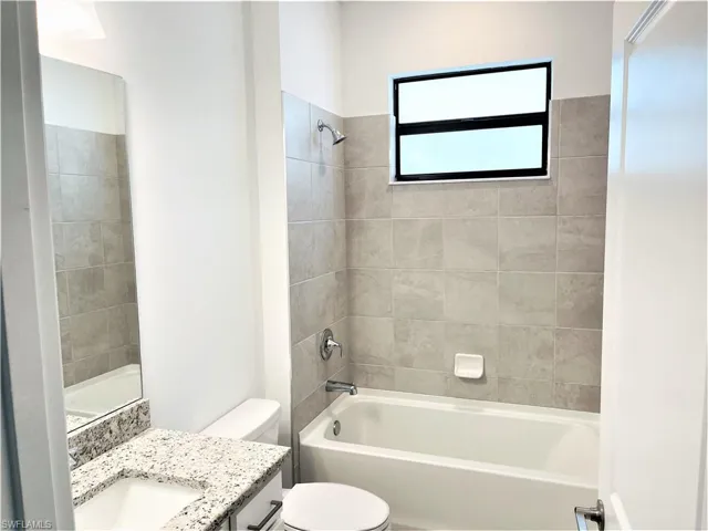 Bathroom with vanity and shower / tub combination