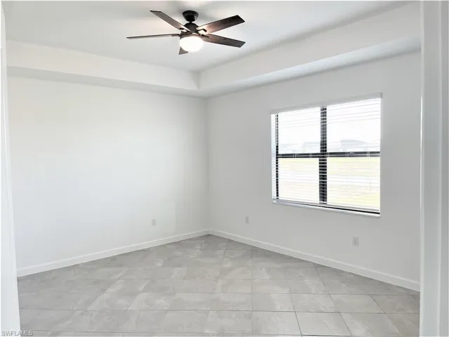 Spare room featuring baseboards and a ceiling fan