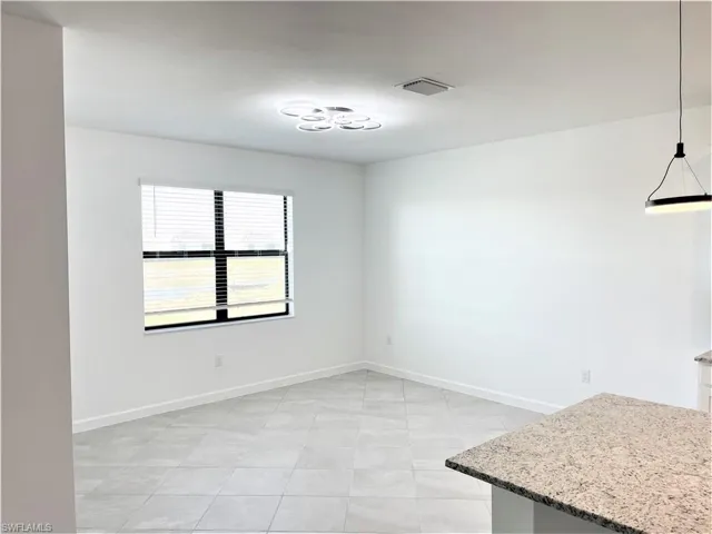 Unfurnished dining area featuring baseboards and light tile patterned floors