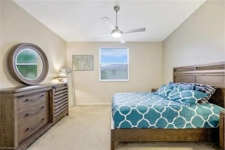 Carpeted bedroom with ceiling fan