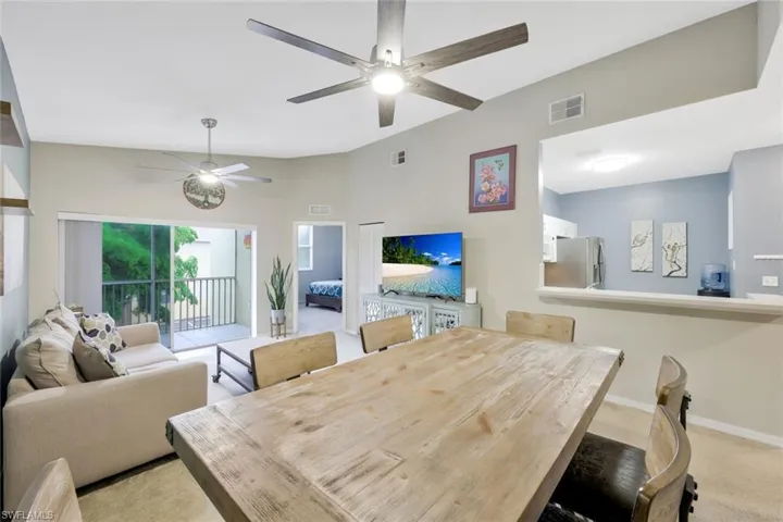 Carpeted dining area with ceiling fan