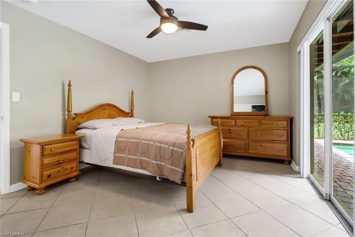 Bedroom featuring ceiling fan, access to exterior, and light tile patterned floors