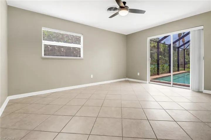 Spare room with ceiling fan and light tile patterned floors