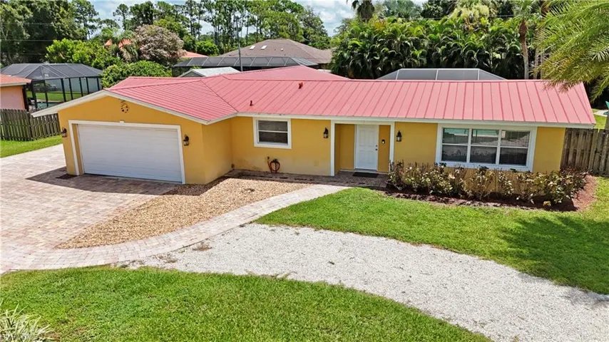 Single story home with a front yard and a garage