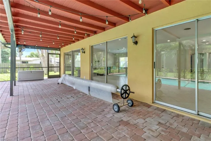 Unfurnished sunroom featuring beam ceiling and wood ceiling