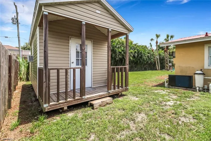 View of outdoor structure with a yard