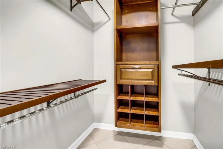 Spacious closet with light tile patterned floors