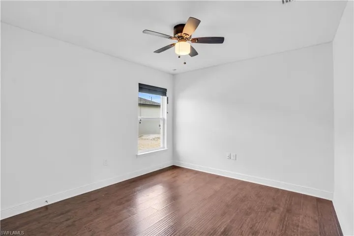 Spare room featuring ceiling fan and hardwood / wood-style flooring