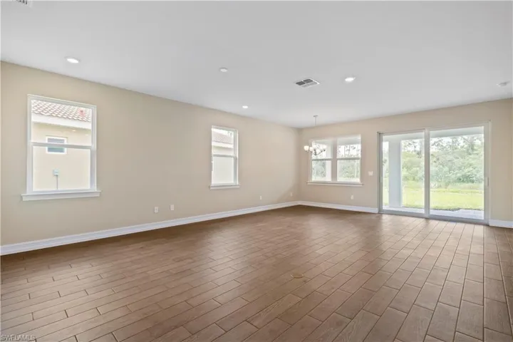 Unfurnished room featuring a chandelier and wood-type flooring